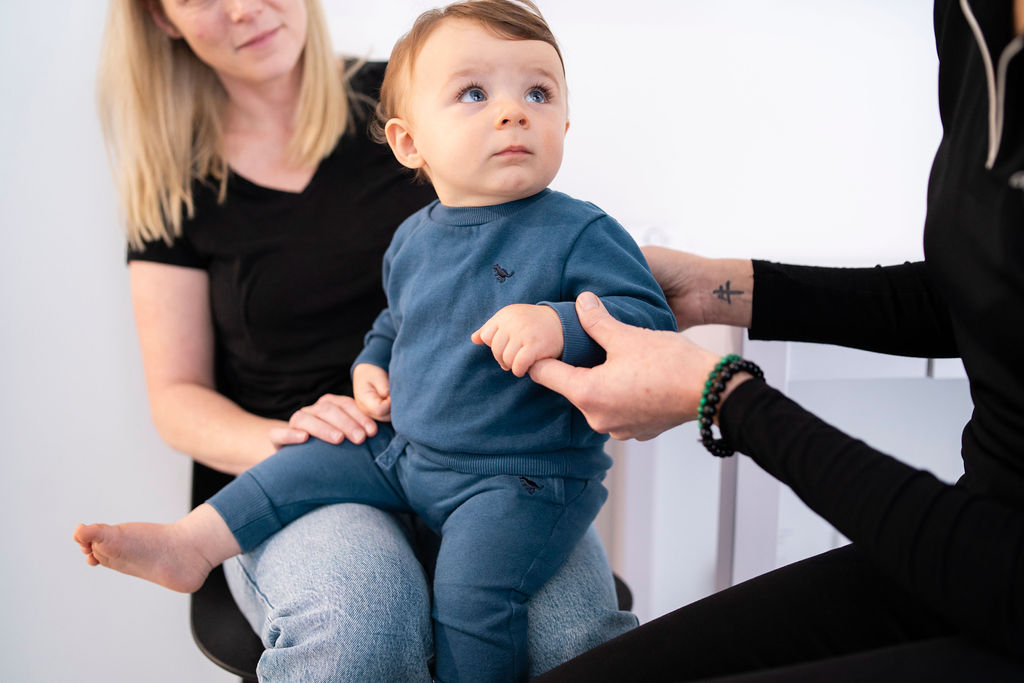 Adult hand holding baby foot